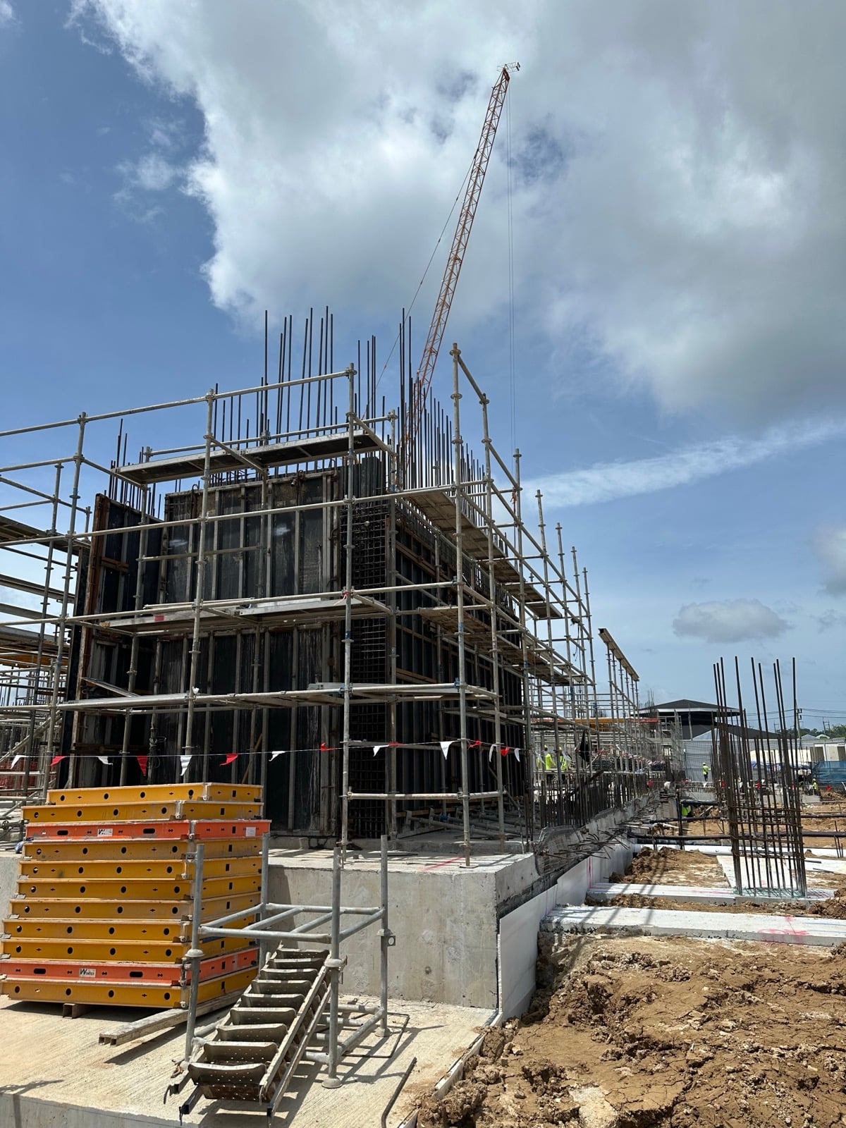Close-up of column formwork with reinforcement bar dowels and scaffolding