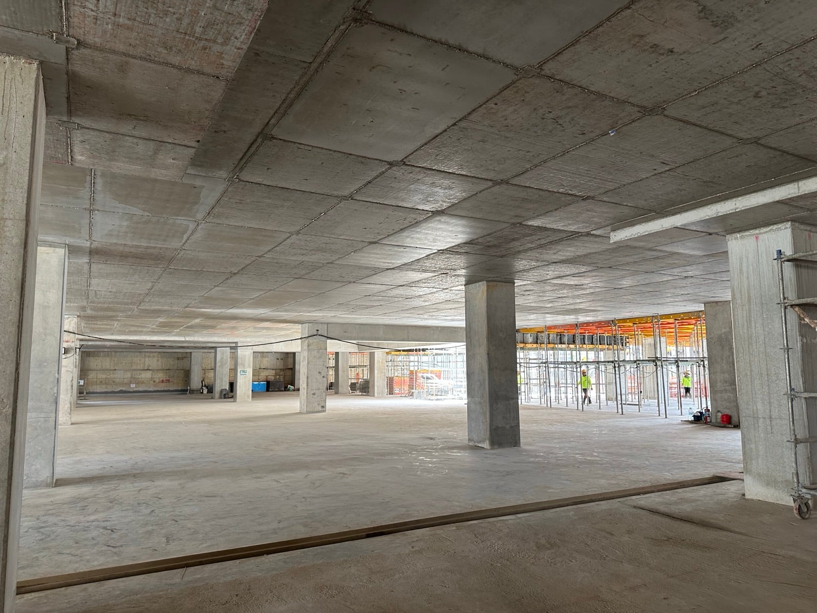 Interior view of a completed structural floor, looking across open bays