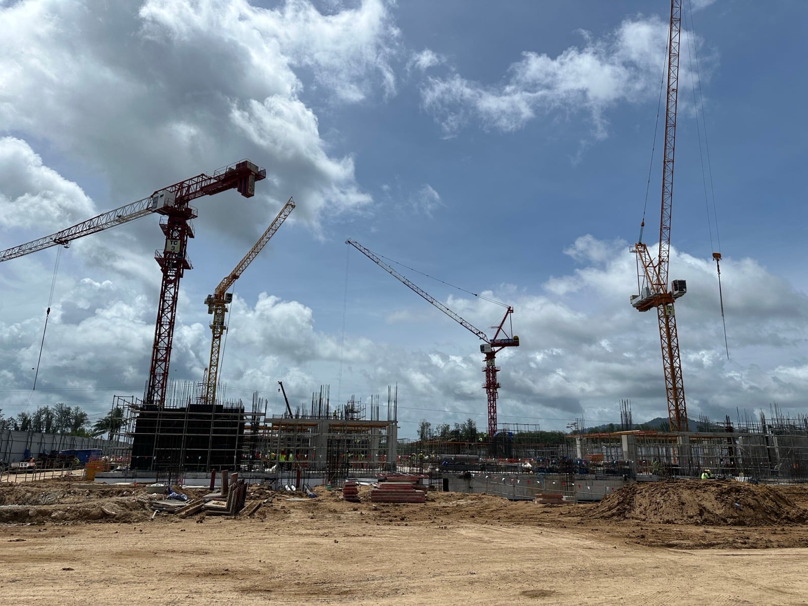 Wide view of the Mai Khao site with four tower cranes over early column works